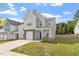 Charming two-story home with light grey siding, brick accents, and a well-manicured lawn at 6512 Bunker Hill Dr, Raleigh, NC 27610