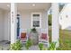 Cozy front porch with rocking chairs, a barrel table, and charming decor at 6512 Bunker Hill Dr, Raleigh, NC 27610