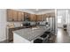 Modern kitchen featuring granite countertops, stainless steel appliances, and a large island at 6512 Bunker Hill Dr, Raleigh, NC 27610