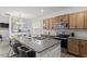 Kitchen and open-concept dining area featuring an island with seating and stainless steel appliances at 6512 Bunker Hill Dr, Raleigh, NC 27610