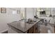 Kitchen island featuring granite countertops, a sink, and seating overlooks the dining and living area at 6512 Bunker Hill Dr, Raleigh, NC 27610