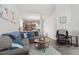 Cozy living room with a comfortable sectional sofa, leather armchair, and view of the kitchen at 6512 Bunker Hill Dr, Raleigh, NC 27610