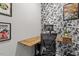 Inviting home office space with floating desk, black and white wallpaper, and comfortable seating at 6512 Bunker Hill Dr, Raleigh, NC 27610