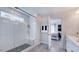 Tiled shower with glass door and seating next to a double vanity and open bedroom at 668 Morning Glade St, Wake Forest, NC 27587