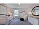 Bedroom with crib, dresser, pink accents, decorative artwork, and plush carpeting at 668 Morning Glade St, Wake Forest, NC 27587