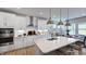 Modern kitchen with white cabinetry, stainless steel appliances, and a large island with seating at 668 Morning Glade St, Wake Forest, NC 27587