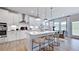 Modern kitchen showcasing an island with pendant lighting and an open dining area at 668 Morning Glade St, Wake Forest, NC 27587