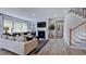 Comfortable living room features hardwood floors, a fireplace, a staircase and a large bright window at 668 Morning Glade St, Wake Forest, NC 27587