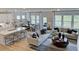 Open-concept living area boasting hardwood floors, a kitchen island, dining space, and comfortable seating at 668 Morning Glade St, Wake Forest, NC 27587