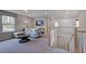 Bright upstairs loft area with couch, TV, and stair access to the lower level at 668 Morning Glade St, Wake Forest, NC 27587