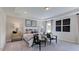 Primary bedroom featuring a tray ceiling, seating area and large windows for natural light at 668 Morning Glade St, Wake Forest, NC 27587
