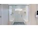 Glass-enclosed shower stall with white tile, seating, and built-in shelving at 668 Morning Glade St, Wake Forest, NC 27587