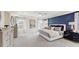 Spacious main bedroom featuring tray ceilings, ceiling fan, en suite, and statement wallpaper at 680 Sun Meadow Dr, Wake Forest, NC 27587