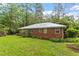 Back exterior of brick home with a lush green lawn at 7 Woodward Way, Chapel Hill, NC 27516
