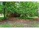 Backyard view featuring foliage, mature trees, and partial home view at 7 Woodward Way, Chapel Hill, NC 27516