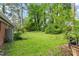 A spacious backyard with lush green grass surrounded by mature trees at 7 Woodward Way, Chapel Hill, NC 27516