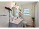 Clean bathroom with a modern vanity, updated fixtures, a round mirror and a walk-in shower at 7 Woodward Way, Chapel Hill, NC 27516