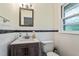 Charming bathroom with updated vanity, mirror, and fixtures, plus white tiled walls at 7 Woodward Way, Chapel Hill, NC 27516