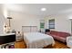 Comfortable bedroom featuring natural lighting and a light-colored wall paint at 7 Woodward Way, Chapel Hill, NC 27516