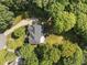 An aerial view highlights the architectural design and landscaping of the property and the surrounding area at 7000 Millstone Ridge Ct, Raleigh, NC 27614