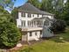 Multi-level back deck with a white railing and lush lawn surrounded by trees at 7000 Millstone Ridge Ct, Raleigh, NC 27614