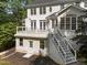 A backyard view showcases a two-story house with a walkout basement, a second story deck and outdoor stairs at 7000 Millstone Ridge Ct, Raleigh, NC 27614