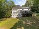 Large backyard with lush greenery and a multi-level deck perfect for outdoor entertaining at 7000 Millstone Ridge Ct, Raleigh, NC 27614
