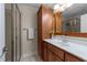 Bathroom with a wood vanity, white countertop, and a glass-enclosed shower at 7000 Millstone Ridge Ct, Raleigh, NC 27614