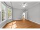 Bright bedroom boasts hardwood floors, a ceiling fan, and a bay window at 7000 Millstone Ridge Ct, Raleigh, NC 27614