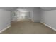 Spacious bedroom featuring a ceiling fan, neutral walls, carpet, and a bright window with trees outside at 7000 Millstone Ridge Ct, Raleigh, NC 27614