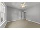 Spacious bedroom featuring a ceiling fan, neutral walls, carpet, and a window at 7000 Millstone Ridge Ct, Raleigh, NC 27614