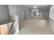 Spacious bonus room featuring a ceiling fan, neutral walls and carpet, and a view of a bright entry hallway at 7000 Millstone Ridge Ct, Raleigh, NC 27614