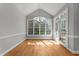 Bright dining room with many windows allowing in abundant natural light with hardwood flooring at 7000 Millstone Ridge Ct, Raleigh, NC 27614