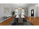 Open dining room with a view of the front door, a decorative rug, and seating for 10 at 7000 Millstone Ridge Ct, Raleigh, NC 27614