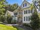 Beautiful two-story home showcasing stone accents, complemented by lush landscaping and mature trees at 7000 Millstone Ridge Ct, Raleigh, NC 27614
