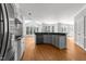 Bright, open kitchen with modern appliances, a large island, and plenty of natural light at 7000 Millstone Ridge Ct, Raleigh, NC 27614