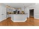 Spacious kitchen boasts white cabinetry, modern appliances, and a large center island with a dark countertop at 7000 Millstone Ridge Ct, Raleigh, NC 27614