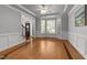 Elegant living room with hardwood floors, bay windows, and decorative ceiling trim at 7000 Millstone Ridge Ct, Raleigh, NC 27614