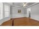 Spacious living room with hardwood floors, decorative ceiling trim, and soft, neutral tones at 7000 Millstone Ridge Ct, Raleigh, NC 27614