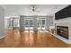 Bright living room with hardwood floors, fireplace, and glass doors to the outdoor deck at 7000 Millstone Ridge Ct, Raleigh, NC 27614