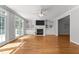 Inviting living room with built-in shelving, fireplace, hardwood floors, and natural light at 7000 Millstone Ridge Ct, Raleigh, NC 27614