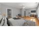 Main bedroom with a ceiling fan, a sitting chair, and an attached bathroom at 7000 Millstone Ridge Ct, Raleigh, NC 27614