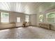 Sunroom with tile flooring and many windows overlooking the landscaped yard at 7000 Millstone Ridge Ct, Raleigh, NC 27614