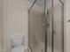 Neutral bathroom with a sleek glass-enclosed shower and modern toilet at 7000 Millstone Ridge Ct, Raleigh, NC 27614