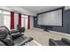 Home theater room featuring a large projection screen, plush seating, and red curtains at 7000 Millstone Ridge Ct, Raleigh, NC 27614