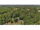 Aerial view of a home surrounded by a lush forest and landscape at 825 Whispering Wind Rd, Burlington, NC 27217