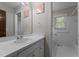 Neat bathroom with natural light, large mirror and white countertops at 825 Whispering Wind Rd, Burlington, NC 27217