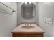 Bathroom featuring a vanity with a light brown stone countertop and a mirrored wall cabinet at 825 Whispering Wind Rd, Burlington, NC 27217