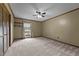 Spacious bedroom featuring a ceiling fan, large window, and ample closet space at 825 Whispering Wind Rd, Burlington, NC 27217