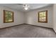 Bedroom featuring a ceiling fan and two windows with natural light at 825 Whispering Wind Rd, Burlington, NC 27217